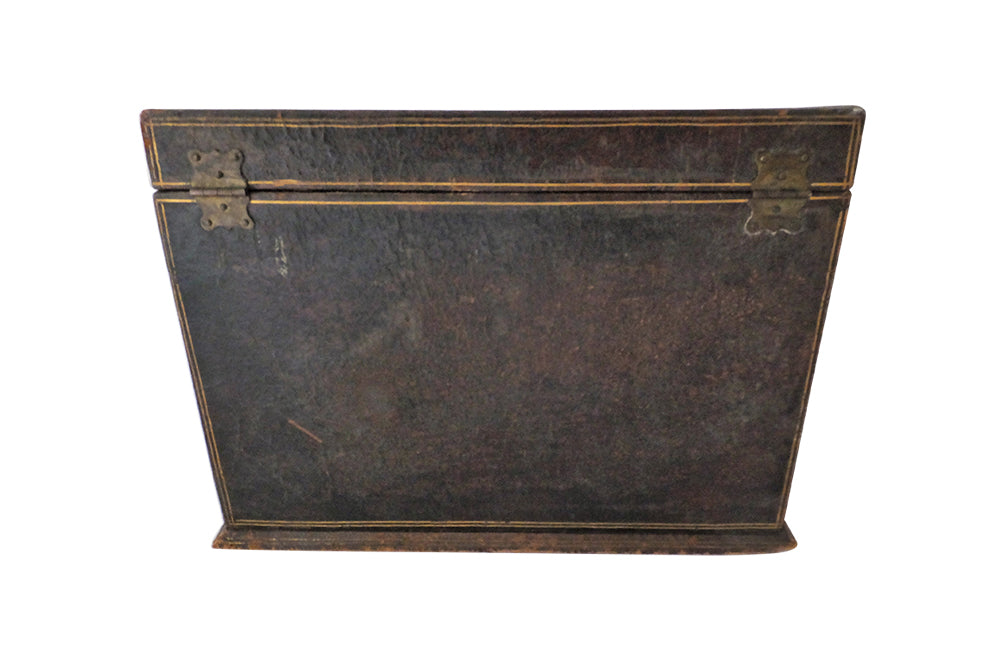 Charming French lidded file box in lovely old worn leather with Neo-Classical embossed motifs, including swans and urns . The base bears the original retail label of Au Bon Marche.