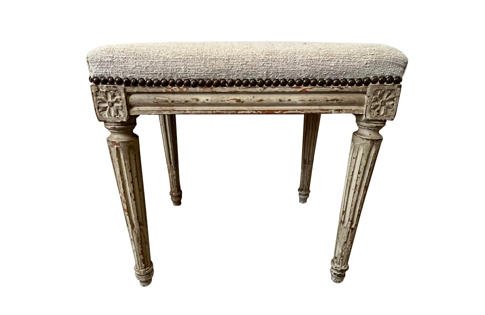 18th century charming painted Louis XVI stool has reeded legs and carving to all sides in the Neo-Classical style.