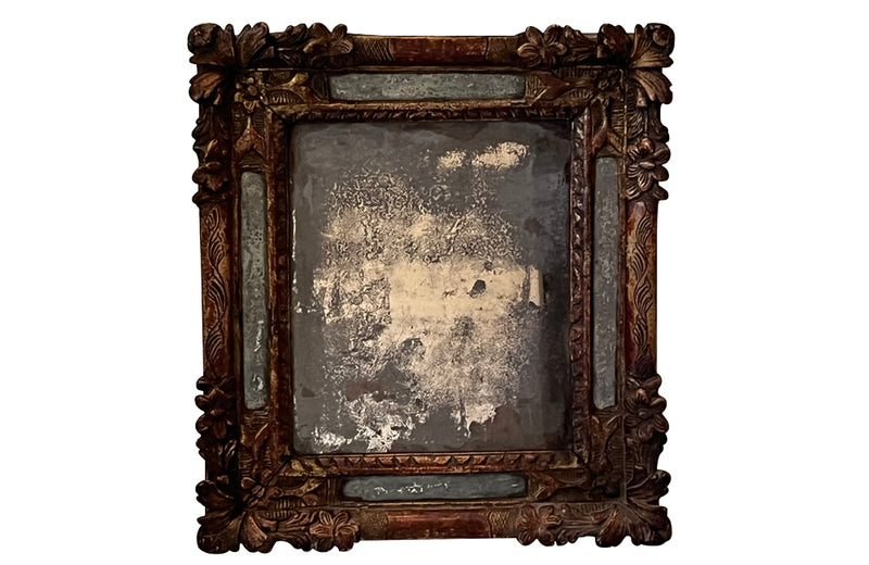 Beautiful early 18th Century French carved gilt wood cushion mirror with foxed glass