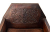 Antique club chair leather with embossed back featuring a putti and scrolled foliate decoration. France.