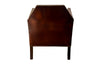 Antique club chair leather with embossed back featuring a putti and scrolled foliate decoration. France.