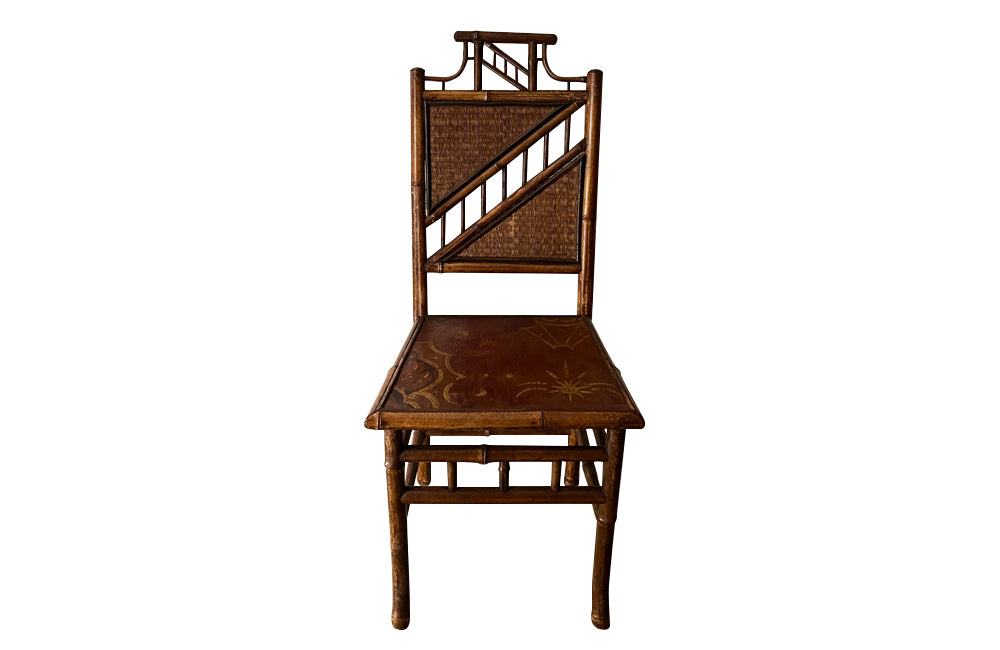 Antique chair made of bamboo with embossed leather seat 