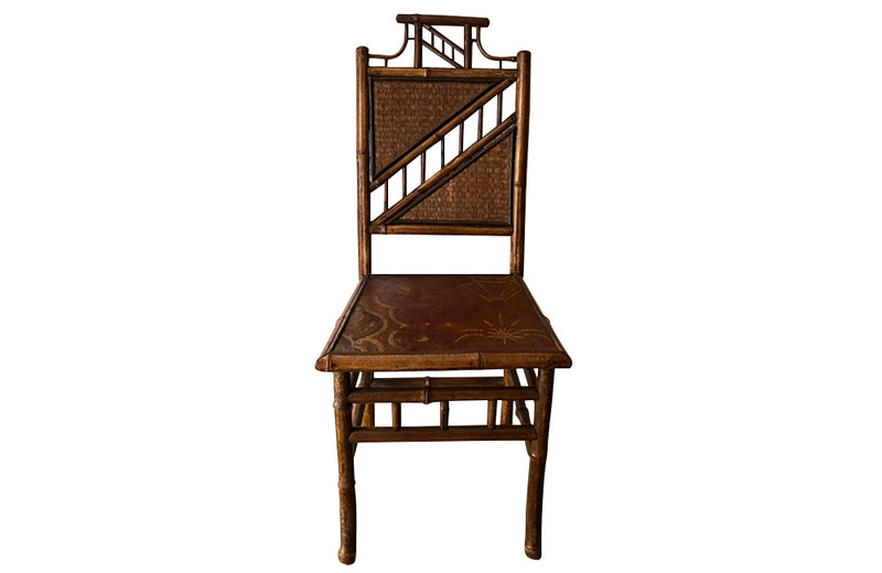 Antique chair made of bamboo with embossed leather seat 