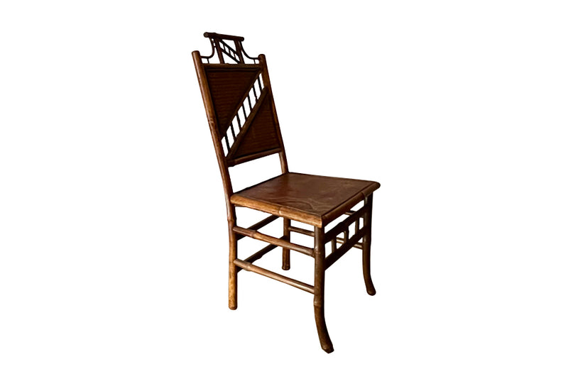 Antique chair made of bamboo with embossed leather seat 