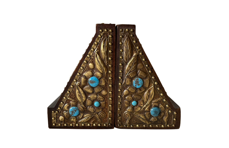 Pair of arts and crafts wood and brass repousee bookends decorated with turquoise blue cabochons.