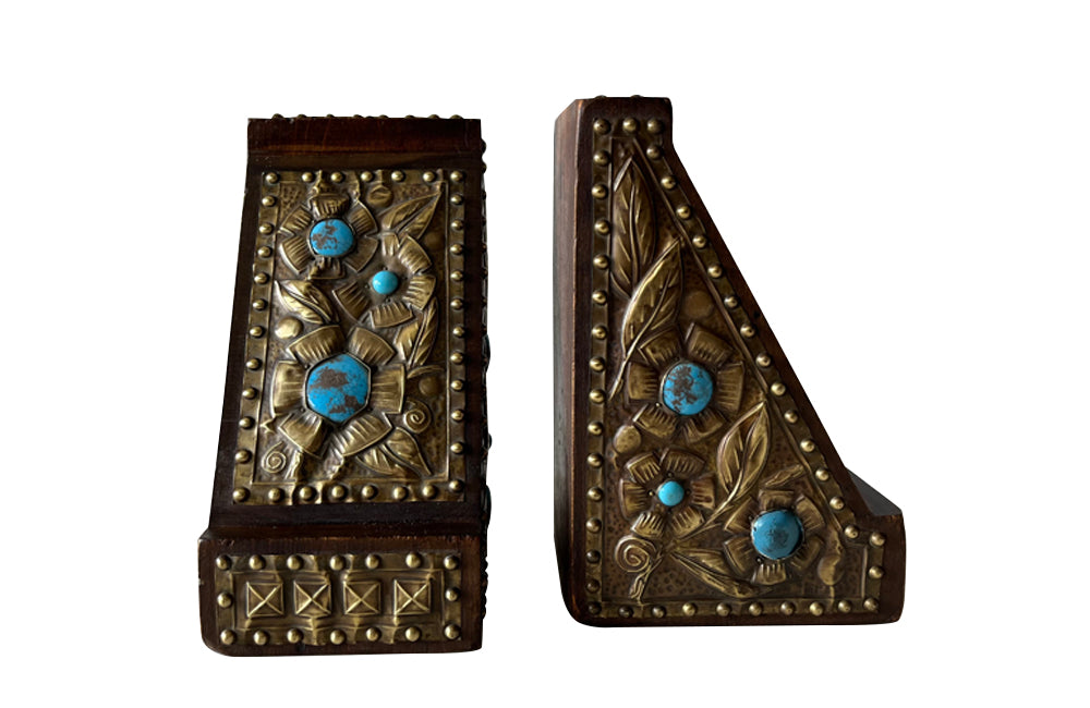 Pair of arts and crafts wood and brass repousee bookends decorated with turquoise blue cabochons.