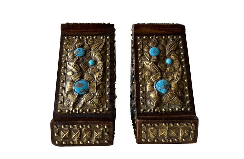 Pair of arts and crafts wood and brass repousee bookends decorated with turquoise blue cabochons.