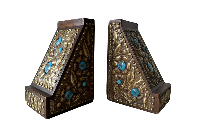 Pair of arts and crafts wood and brass repousee bookends decorated with turquoise blue cabochons.