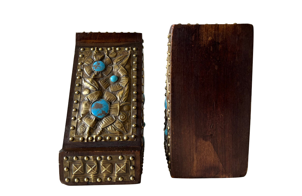 Pair of arts and crafts wood and brass repousee bookends decorated with turquoise blue cabochons.