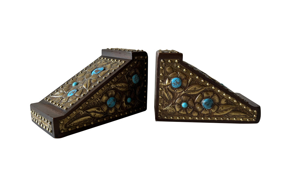 Pair of arts and crafts wood and brass repousee bookends decorated with turquoise blue cabochons.