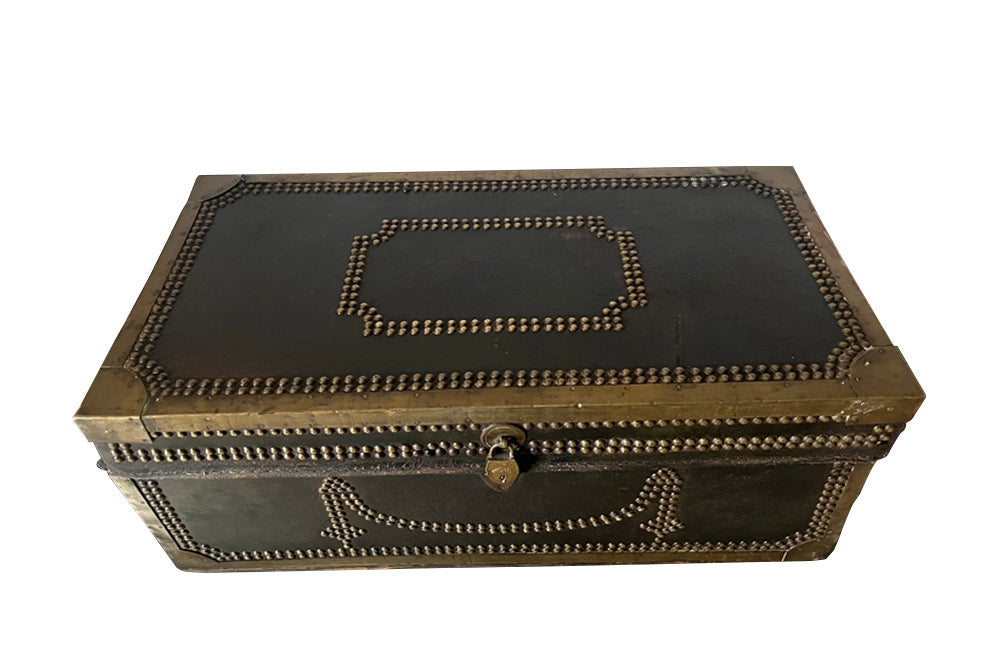 An early 19th century brass banded and studded leather trunk