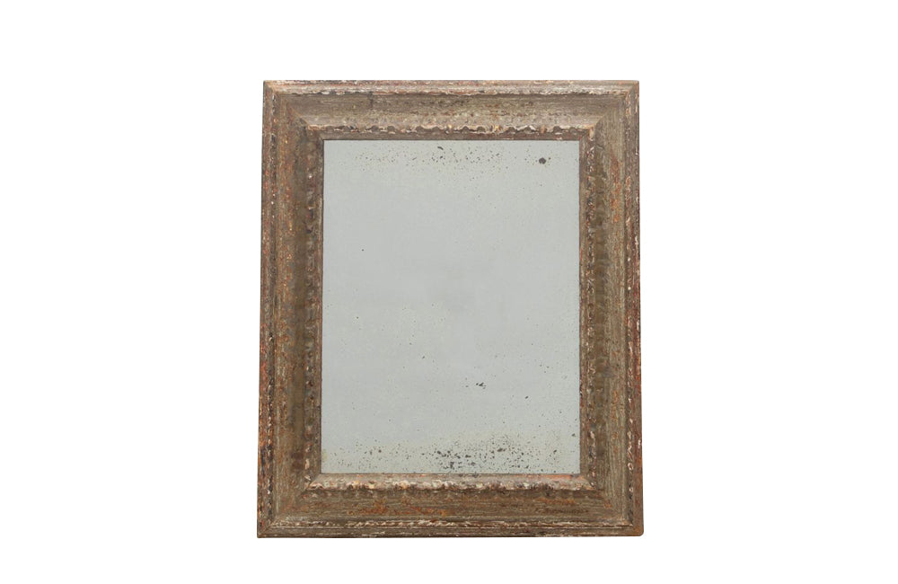 19th century French carved framed mirror with foxed mirror glass.