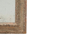 19th century French carved framed mirror with foxed mirror glass.