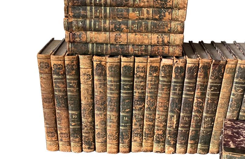 Early 19th century collection of thirty eight worn leather spined books with purple marbled paper covered boards.