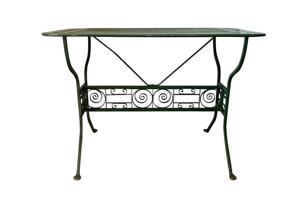 Late 19th Century iron garden table with pierced top and decorative cross stretcher with scroll iron work.