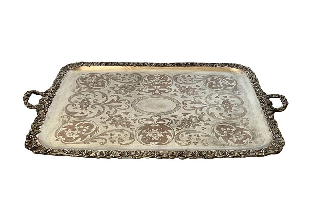 Large and ornately etched serving tray with fruiting grape vine surround and handles 
