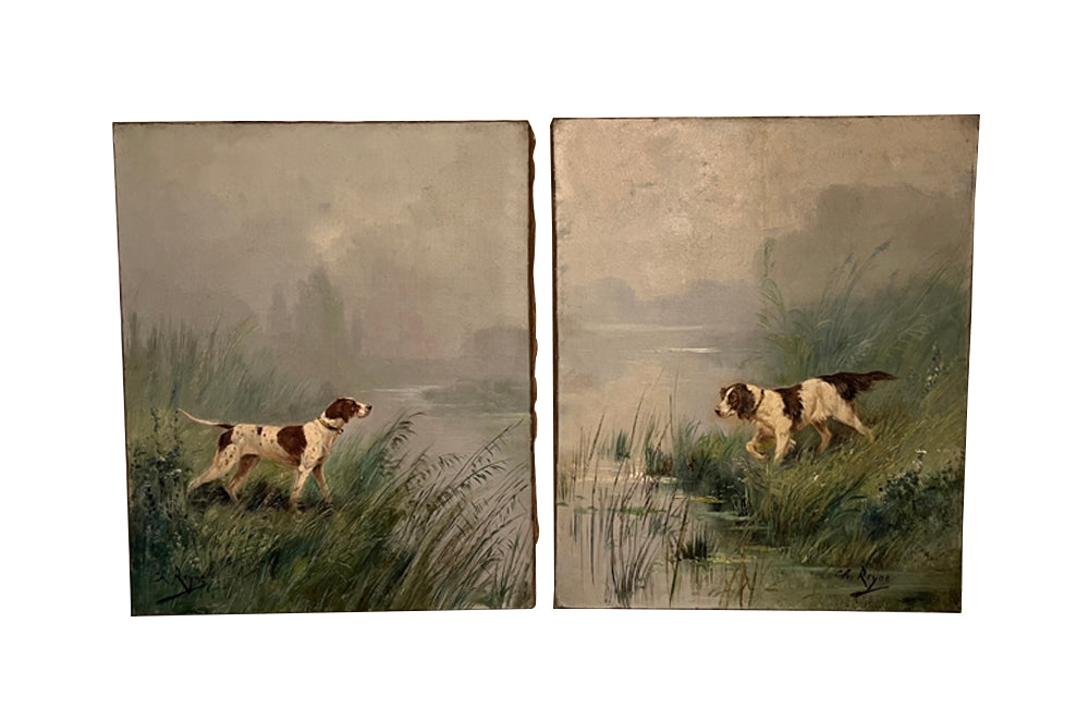 Pair of oil on canvas portraits of a retiever dogs, both depicted on the banks of a river.Unframed. Signed by the artist Charle Andre Reyne