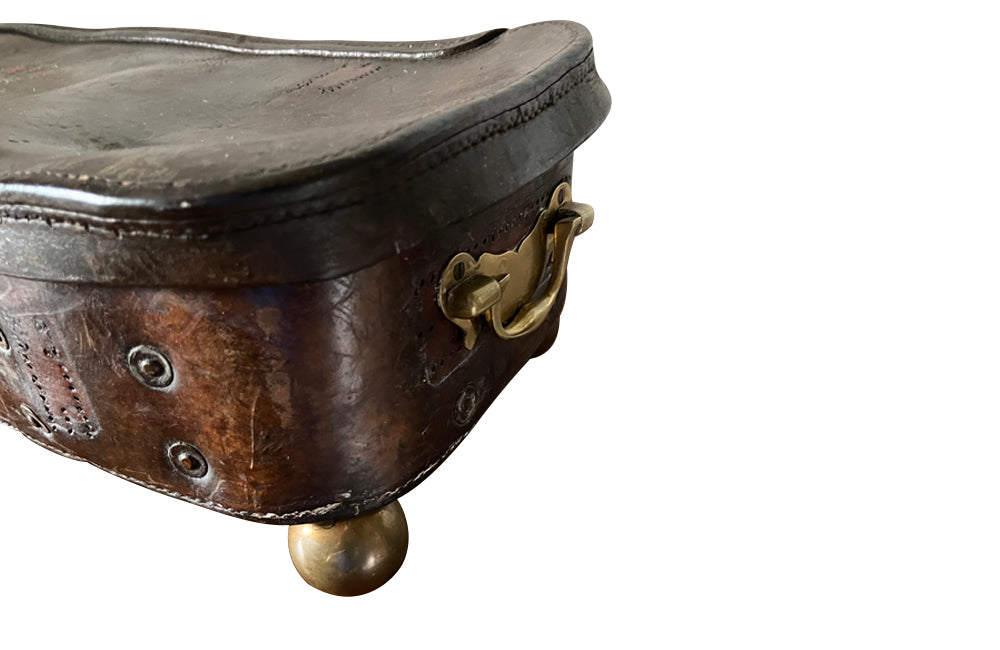 19th century leather lidded box with brass side handles and brass ball feet. Bears a later Crowned Royal Monogram of G.R.