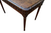 19th century walnut desk decorated with carved with Neo-Classical motifs to all sides.