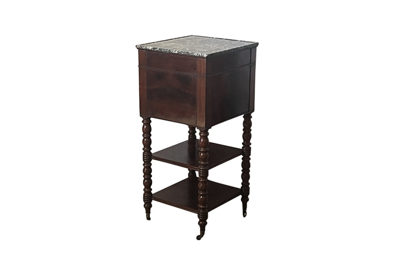 Antique side table  - Antique French Mahogany side table or nightstand with marble top and turned legs with brass sabots and casters.