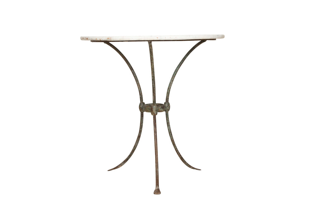 Antique iron garden table with splayed legs and pretty cast iron central floral medallion. Garden antiques