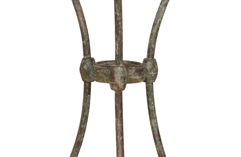 Antique iron garden table with splayed legs and pretty cast iron central floral medallion. Garden antiques
