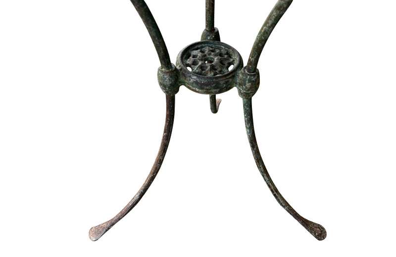 Antique iron garden table with splayed legs and pretty cast iron central floral medallion. Garden antiques