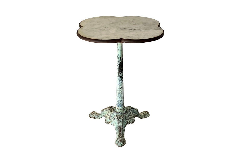 Antique bistro table with quatrefoil clover shaped marble top and enamelled iron base. French. foundry stamps to feet of Charlionais Pourailly & Cie