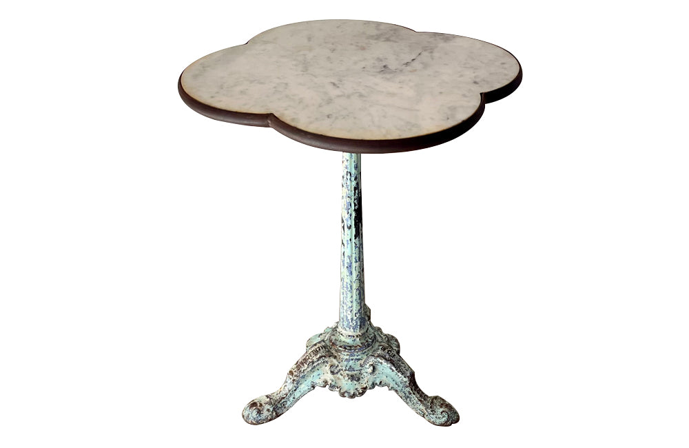 Antique bistro table with quatrefoil clover shaped marble top and enamelled iron base. French. foundry stamps to feet of Charlionais Pourailly & Cie
