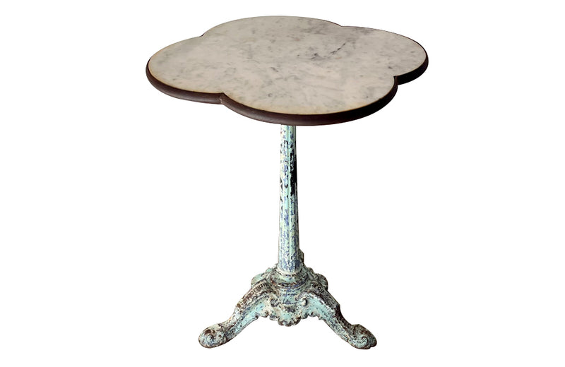 Antique bistro table with quatrefoil clover shaped marble top and enamelled iron base. French. foundry stamps to feet of Charlionais Pourailly & Cie