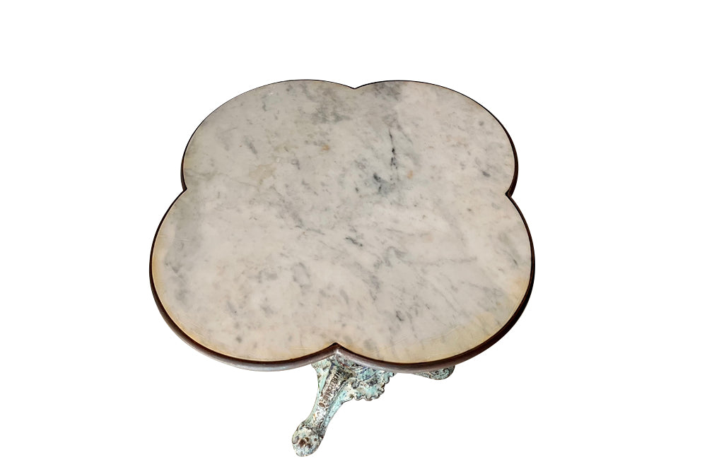 Antique bistro table with quatrefoil clover shaped marble top and enamelled iron base. French. foundry stamps to feet of Charlionais Pourailly & Cie