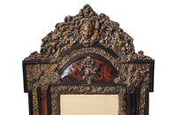 Antique mirror Louis XIV style French with faux tortoiseshell veneer and repousee brass decoration. Richly decorated with floral, foliate and fruit motif.