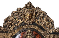 Antique mirror Louis XIV style French with faux tortoiseshell veneer and repousee brass decoration. Richly decorated with floral, foliate and fruit motif.