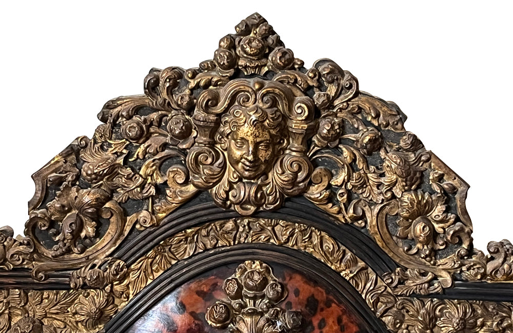 Antique mirror Louis XIV style French with faux tortoiseshell veneer and repousee brass decoration. Richly decorated with floral, foliate and fruit motif.