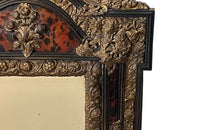 Antique mirror Louis XIV style French with faux tortoiseshell veneer and repousee brass decoration. Richly decorated with floral, foliate and fruit motif.