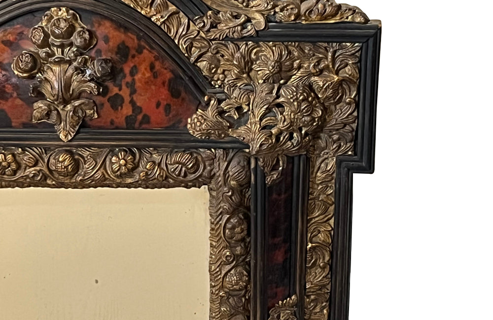 Antique mirror Louis XIV style French with faux tortoiseshell veneer and repousee brass decoration. Richly decorated with floral, foliate and fruit motif.