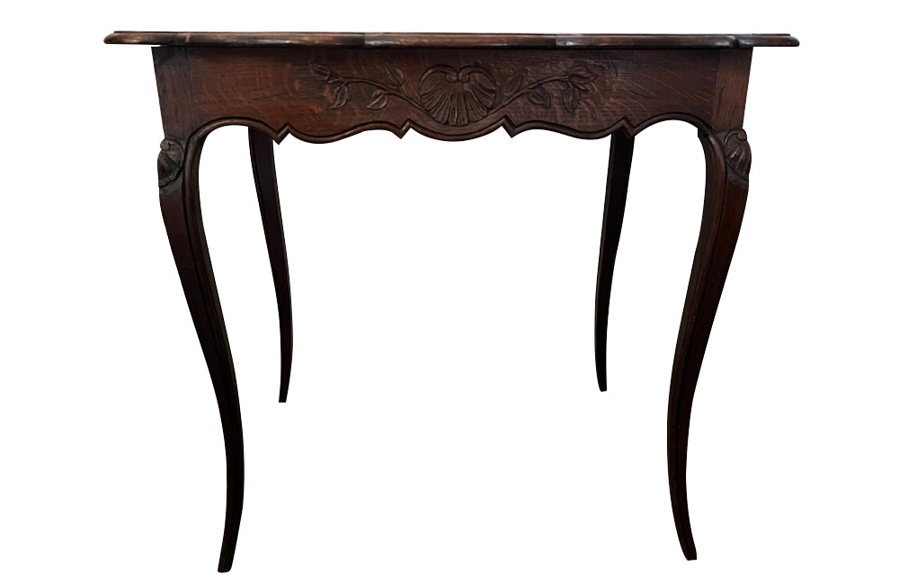 Small 19th Century French oak writing table in the Louis XV style.