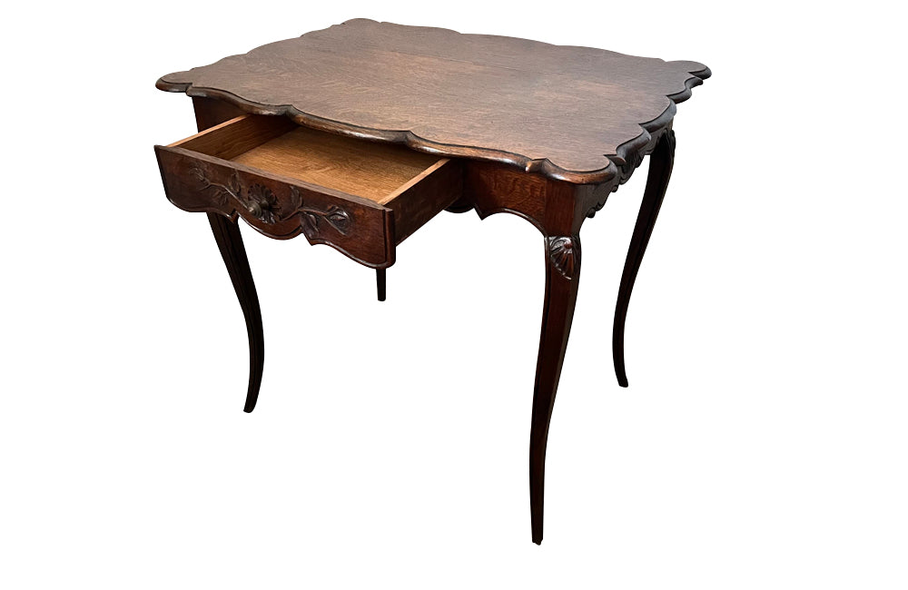 Small 19th Century French oak writing table in the Louis XV style.