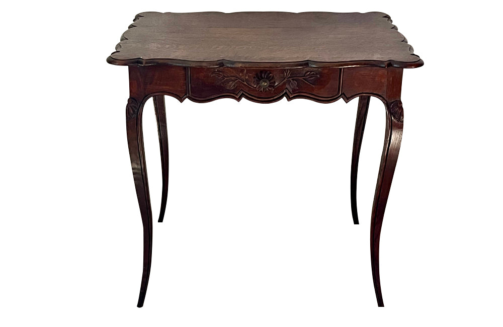 Small 19th Century French oak writing table in the Louis XV style.