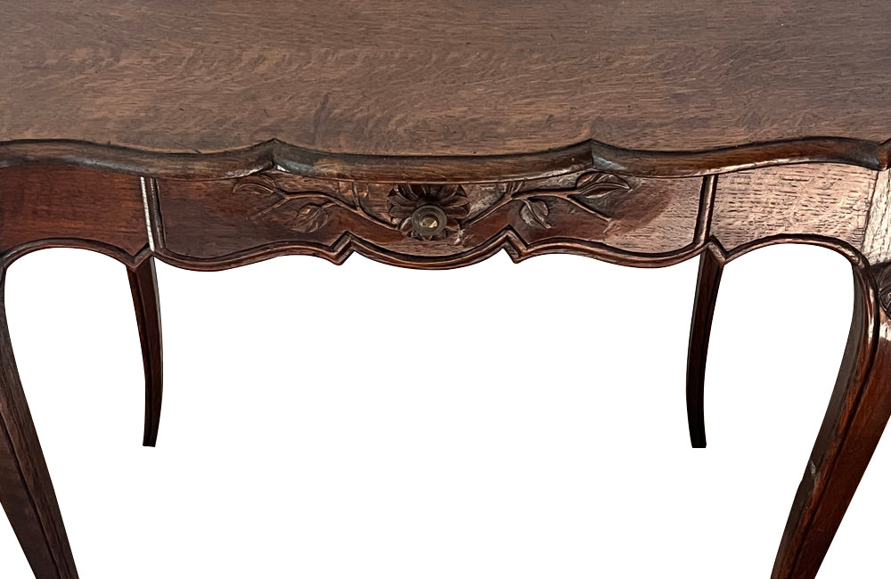 Small 19th Century French oak writing table in the Louis XV style.