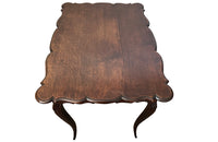 Small 19th Century French oak writing table in the Louis XV style.