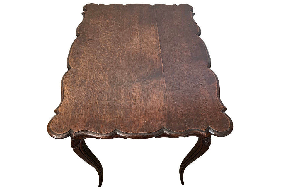 Small 19th Century French oak writing table in the Louis XV style.