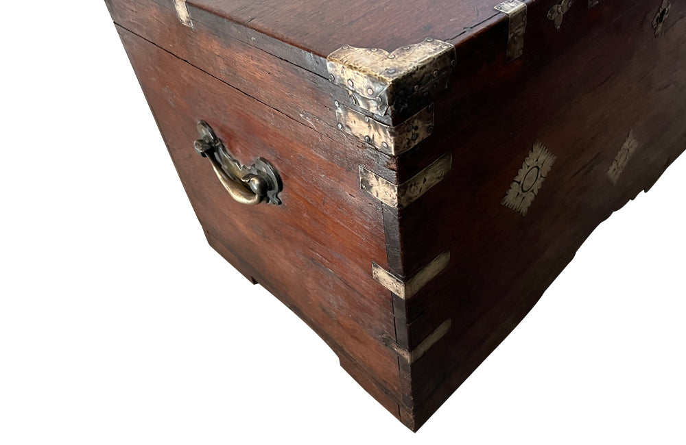 19th Century Anglo-Indian teak lidded trunk with brass ornamentation.