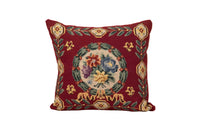 19th Century French needlepoint pillow featuring a classic floral wreath medallion on a deep burgundy ground.