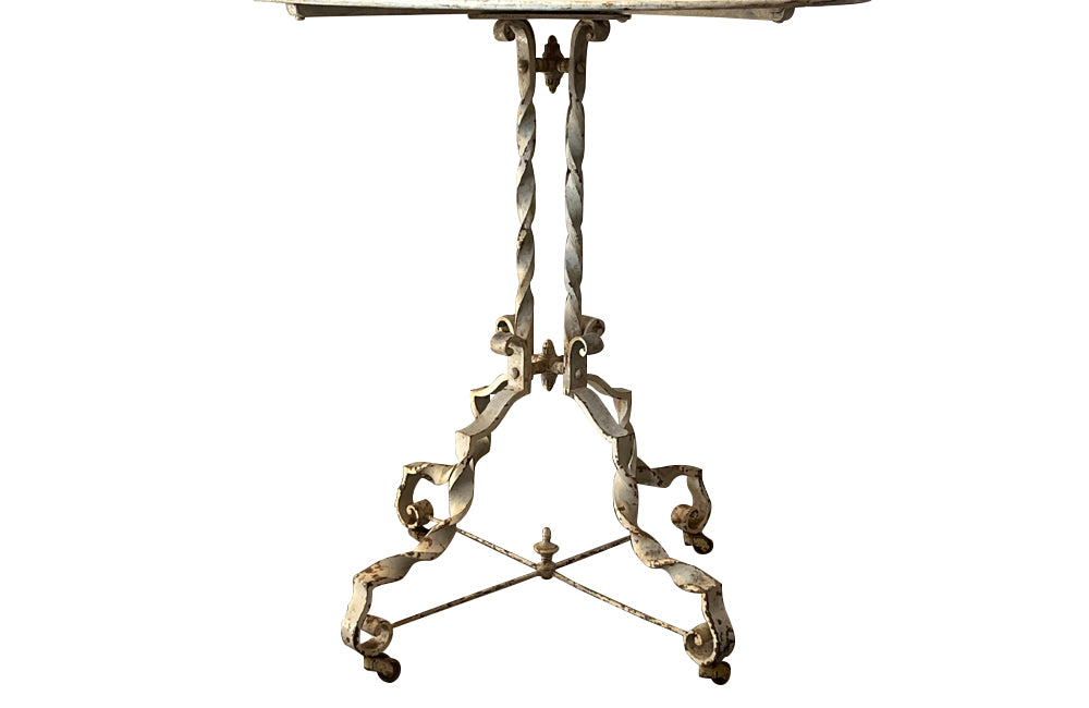 Antique iron table French orangery table on twisted iron base with feet terminating on casters. French Antique Furniture.