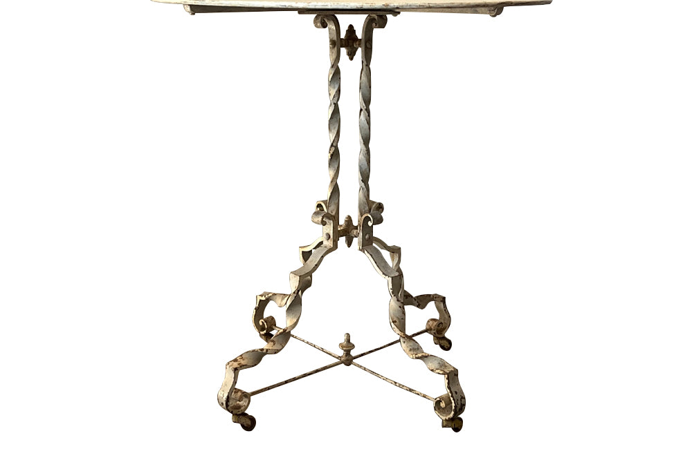 Antique iron table French orangery table on twisted iron base with feet terminating on casters. French Antique Furniture.