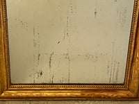 Antique mirror French Louis Philippe giltwood 19th Century with beaded inner surround and Neo-Classical foliate decoration to the frame.