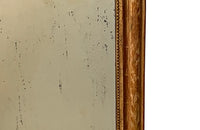 Antique mirror French Louis Philippe giltwood 19th Century with beaded inner surround and Neo-Classical foliate decoration to the frame.