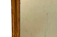 Antique mirror French Louis Philippe giltwood 19th Century with beaded inner surround and Neo-Classical foliate decoration to the frame.