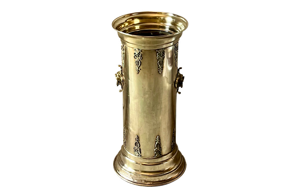 19th century brass umbrella or stick stand with lion head and bar handles and neo-classical style ornamentation.